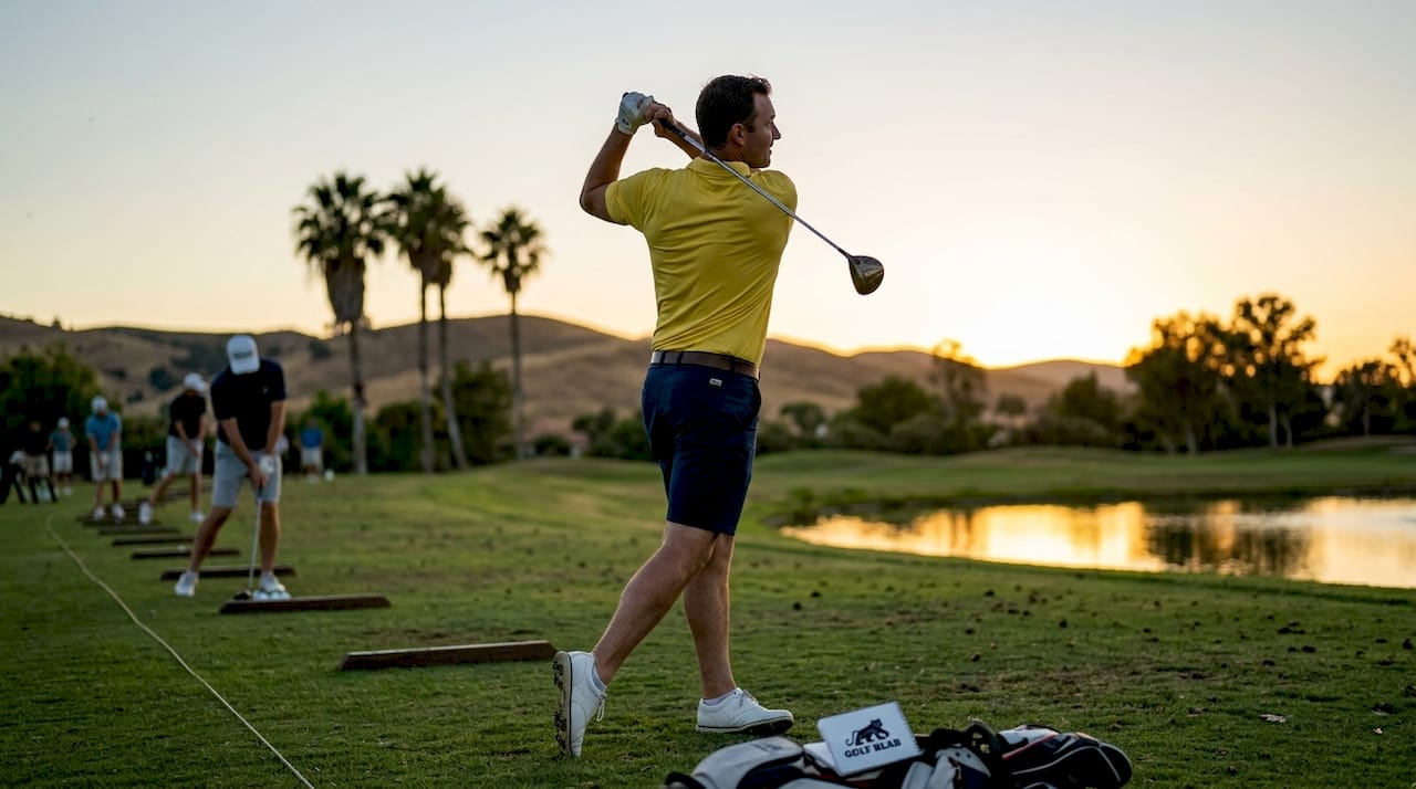 Golfer finishing perfect golf swing follow through pose