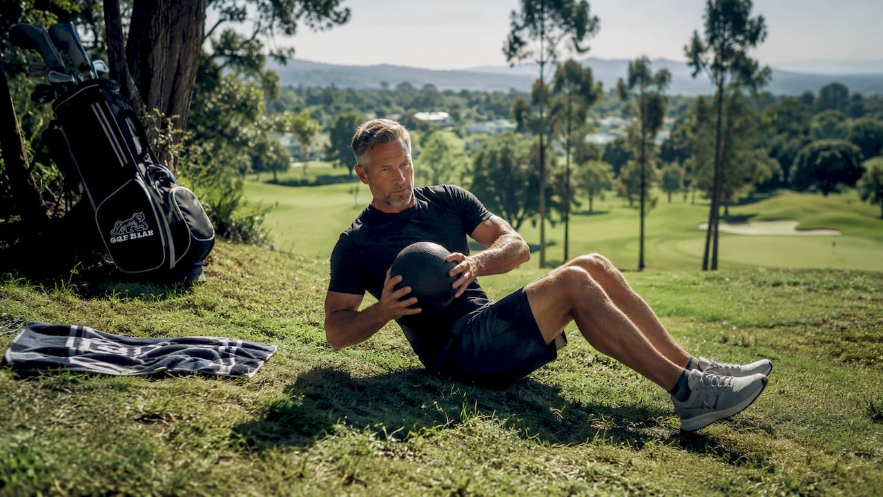 Golfer performing core exercise outdoors
