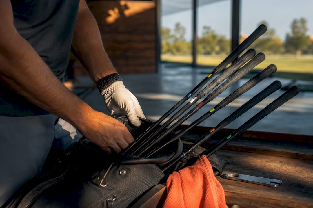 Golfer organizing color-coded club labels
