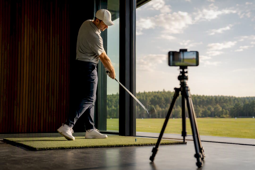 Golfer reviewing swing feedback during practice