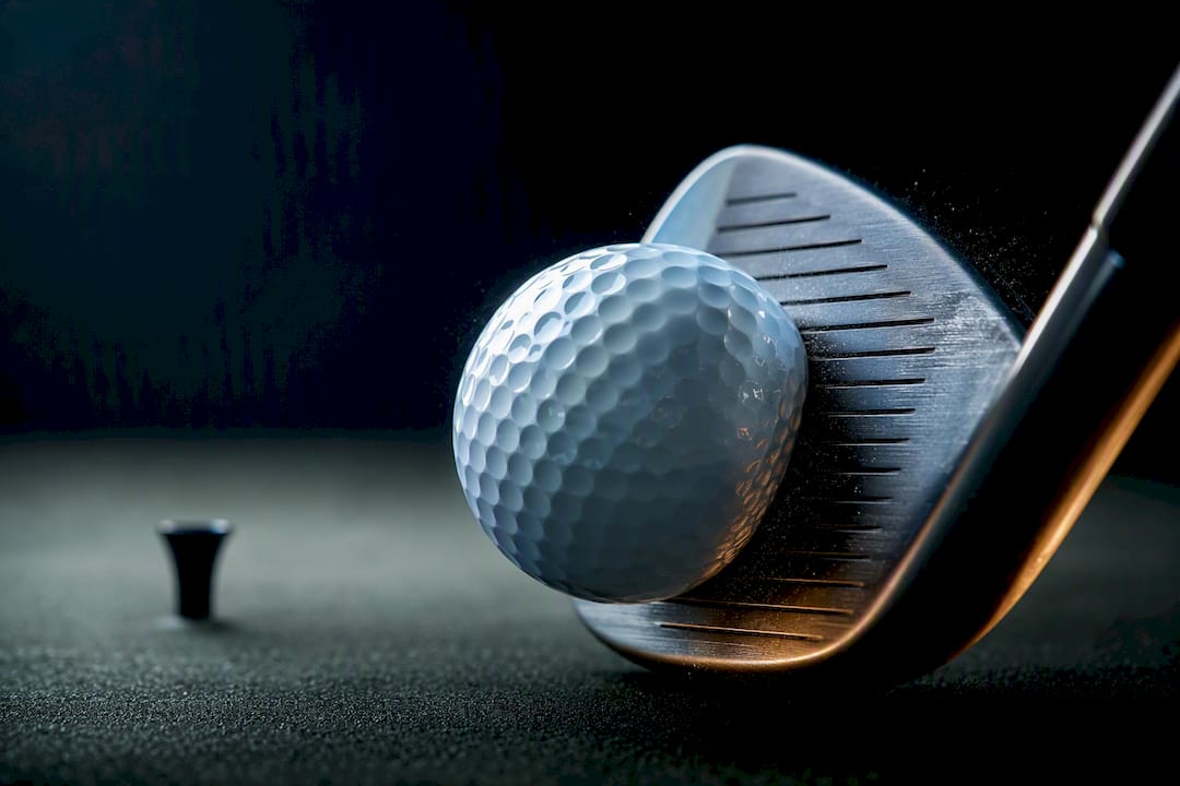 Golf ball compressing against clubface