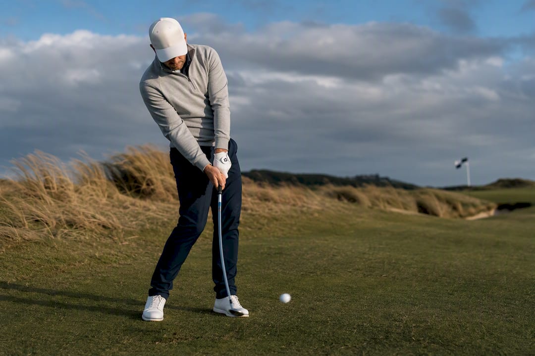Golfer playing a low knockdown shot in wind